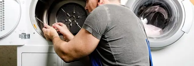 Dryer repair technician fixing a clothes dryer drum in Boise, ID