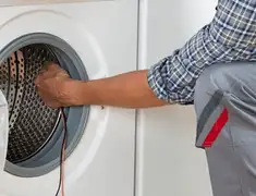 Dryer repair technician diagnosing and servicing a clothes dryer in Boise, ID