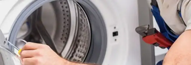 Appliance technician repairing a clothes dryer drum and internal parts in Boise, ID
