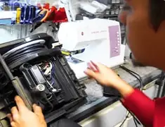 Vacuum repair technician servicing internal components on a workbench in Boise, ID