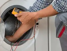 Washing machine repair technician testing a front-load washer with diagnostic tools in Boise, ID